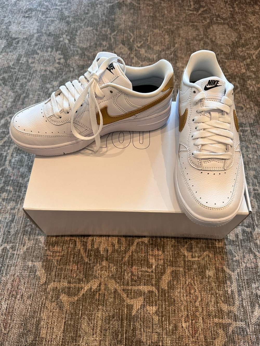 NIKE Air Force 1 Unisex White Sneakers with Gold Swoosh